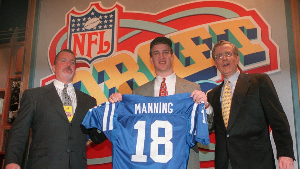 IRSAY TAGLIABUE Quarterback Peyton Manning, of Tennissee, holds holds up an Indianapolis Colts jersey as he is flanked by Colts owner Jim Irsay, left, and NFL Commissioner Paul Tagliabue, in New York after being chosen by the Colts as the No.
