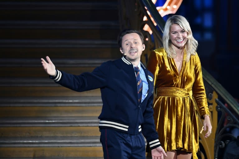 Norwegian forward Ada Hegerberg (R) stands alongside French DJ and producer Martin Solveig (L) after receiving the 2018 women's Ballon d'Or award