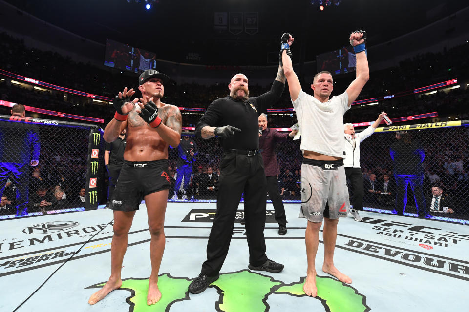 ANAHEIM, CALIFORNIA - AUGUST 17:  (R-L) Nate Diaz celebrates his victory over Anthony Pettis in their welterweight bout during the UFC 241 event at the Honda Center on August 17, 2019 in Anaheim, California. (Photo by Josh Hedges/Zuffa LLC/Zuffa LLC via Getty Images)