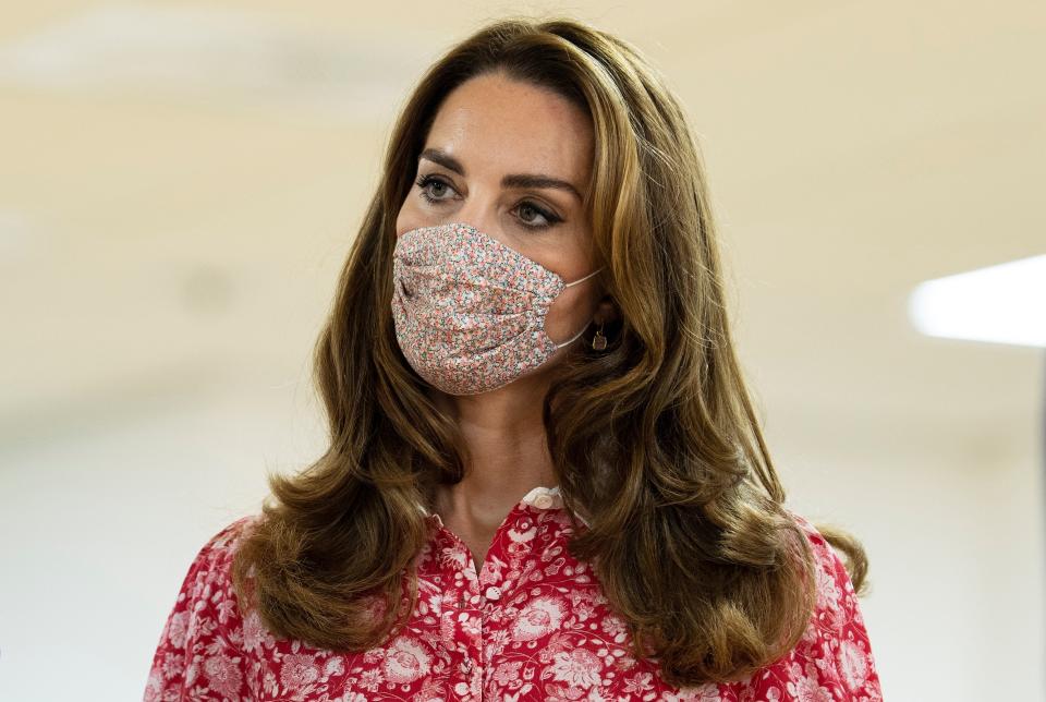 Catherine, Duchess of Cambridge wearing a floral face covering. (Photo by IAN VOGLER/POOL/AFP via Getty Images)