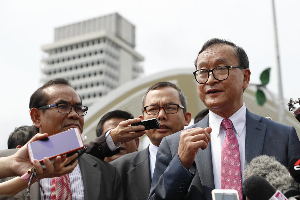 Cambodia's exiled opposition leader Sam Rainsy talks to the media outside Parliament House in Kuala Lumpur, Malaysia, Tuesday, Nov. 12, 2019. Rainsy landed in Kuala Lumpur in a bid to return to his homeland after Thailand had earlier blocked him from entering. (AP Photo/Vincent Thian)