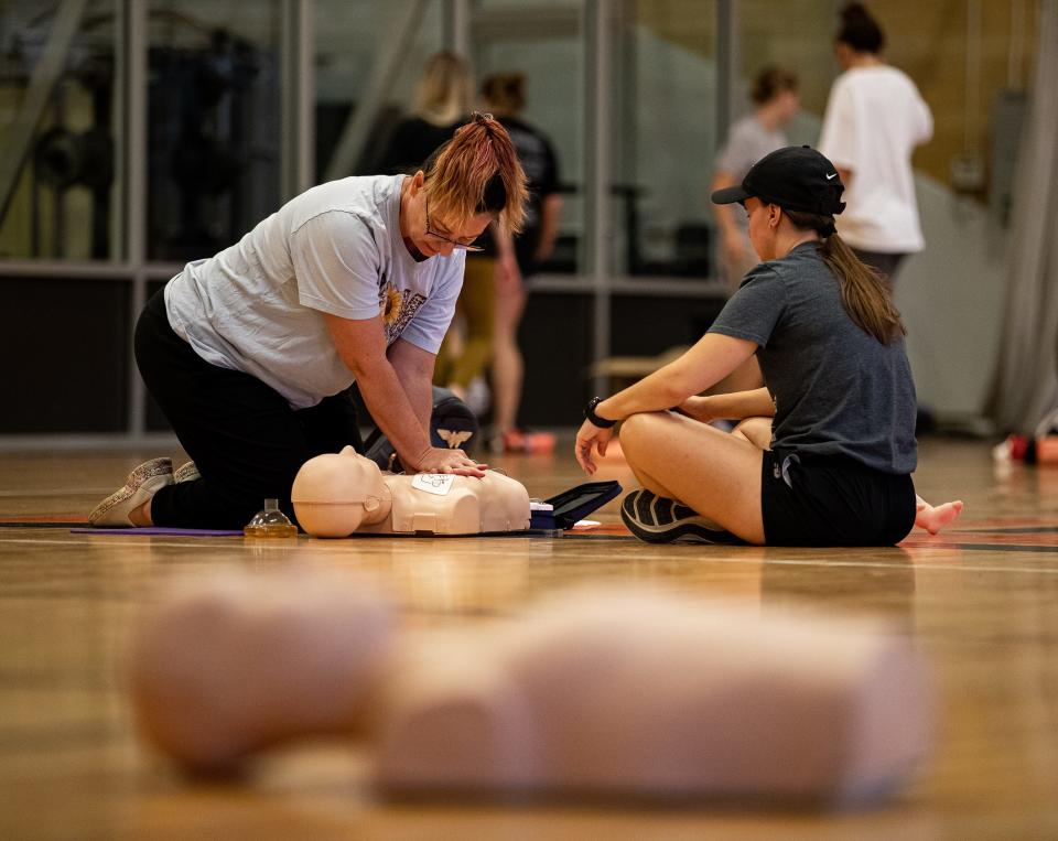 JCPS coaches performed CPR during a training session at Fern Creek High School. The training was part of Jefferson County Public Schools' annual fall clinic, which reviewed topics like mental health, nutrition and first-aid training. July 7, 2023