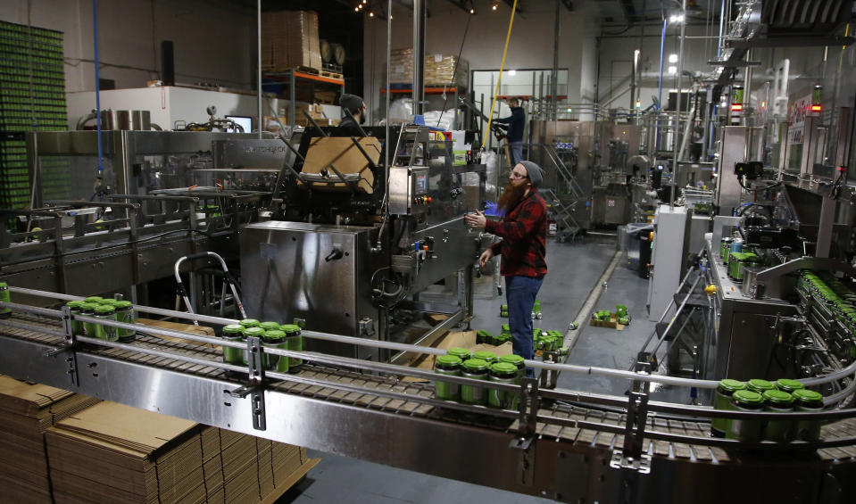 Darby Rose works on the packaging line at COOP Ale Works in Oklahoma City, Friday, Jan. 18, 2019. COOP Ale Works, which distributes in six states including Oklahoma and Kansas, has discontinued two of its three 3.2 percent brews. (AP Photo/Sue Ogrocki)