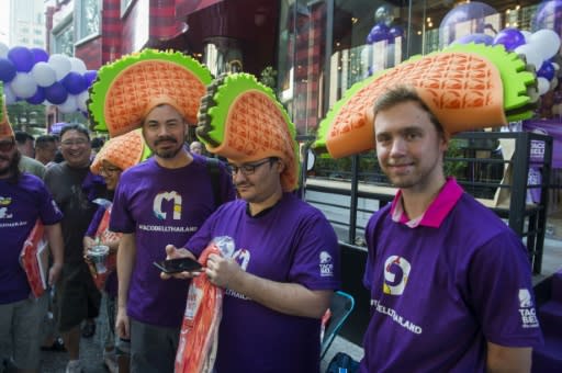 Fast food fans wait in line outside the first Taco Bell restaurant to open in Thailand