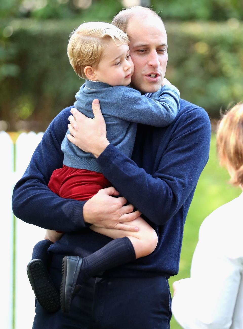 Prince George hugs Prince William.