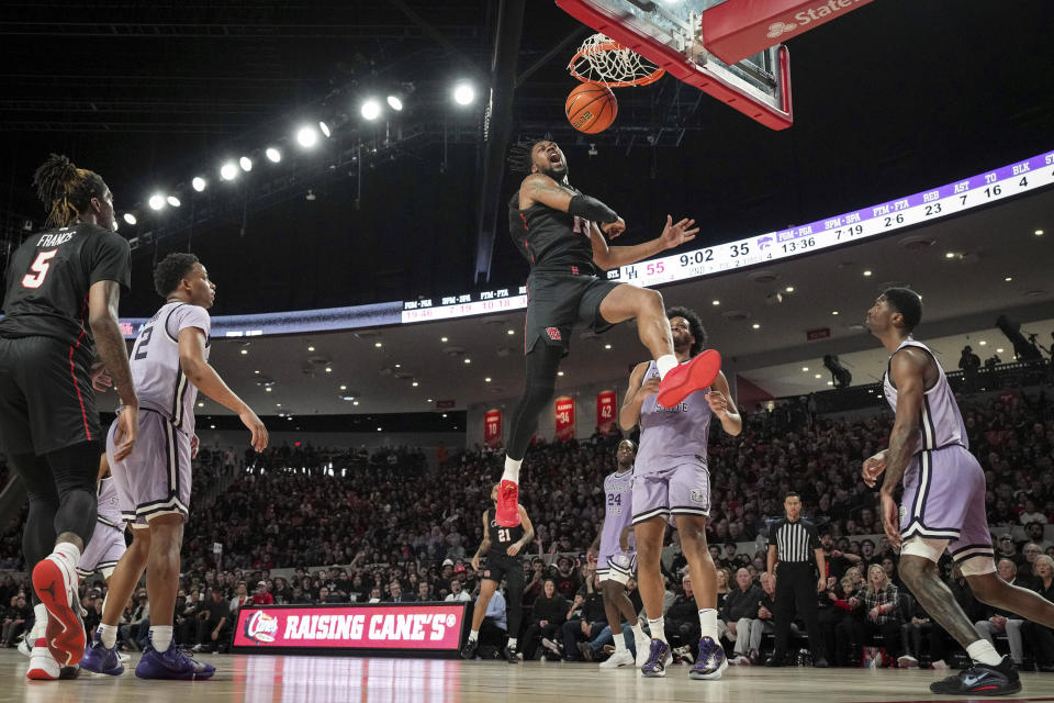 Houston forward J'Wan Roberts (13) celebrates as he dunks the ball during the second half of an NCAA college basketball game against Kansas State, Saturday, Jan. 27, 2024, in Houston. (Jon Shapley/Houston Chronicle via AP)