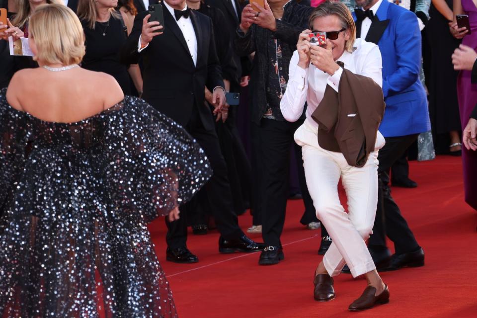 Chris Pine, right, takes a picture of Florence Pugh upon arrival (Joel C Ryan/Invision/AP)