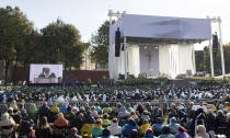 Pope Francis is seen on a giant screen at left, as he celebrates an open-air Mass at Santakos Park, in Kaunas, Lithuania, Sunday, Sept. 23, 2018. Francis is paying tribute to Lithuanians who suffered and died during Soviet and Nazi occupations on the day the country remembers the near-extermination of its centuries-old Jewish community during the Holocaust. (AP Photo/Mindaugas Kulbis)