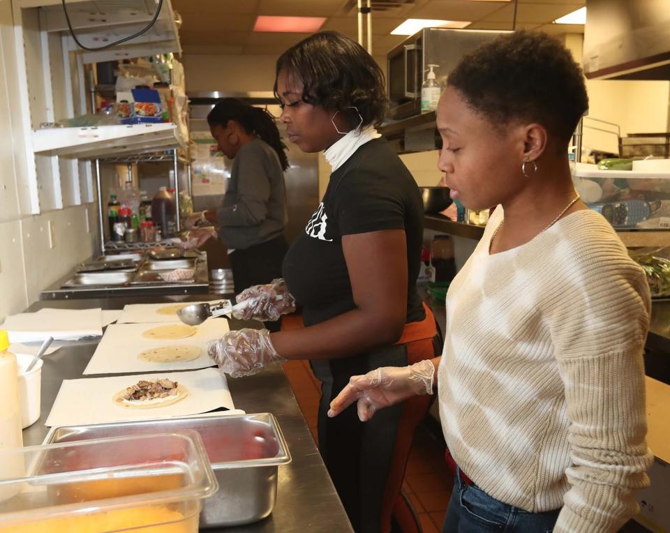 Chef Jen Tidwell instructs student JaQuae Blair on how to make tacos during on-site restaurant training in the kitchen at NoHi as part of Jump On Board for Success' (JOBS) culinary program in Akron.