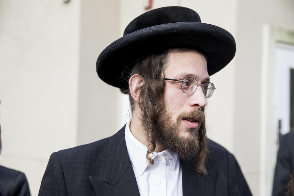 Josef Gluck talks to members of the media about how he obstructed the attacker Saturday night at a rabbi's home. (Photo: ASSOCIATED PRESS)