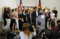 Tom Teves, at podium, group spokesman of the families of the victims of the Colorado theatre shooting, speaks during a press conference in Aurora, Colo., on Tuesday, Aug. 28, 2012. (AP Photo/Chris Schneider)