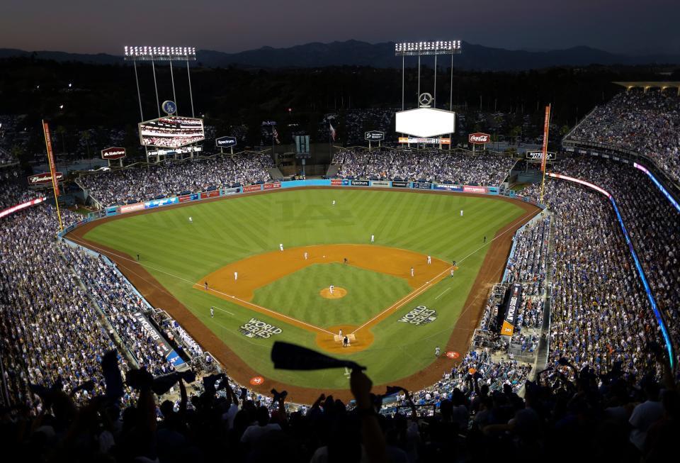 FILE - In this Oct. 25, 2017, file photo, the Houston Astros and the Los Angeles Dodgers play in Game 2 of the baseball World Series at Dodger Stadium in Los Angeles. There is no Midsummer Classic in baseball this season. There has not even been a regular season game yet because of the coronavirus. Instead of MLB's best gathering this week at Dodger Stadium for the All-Star Game, players are at their home ballparks for summer camp to prepare for the start of the season July 23-24. (AP Photo/Tim Donnelly, File)