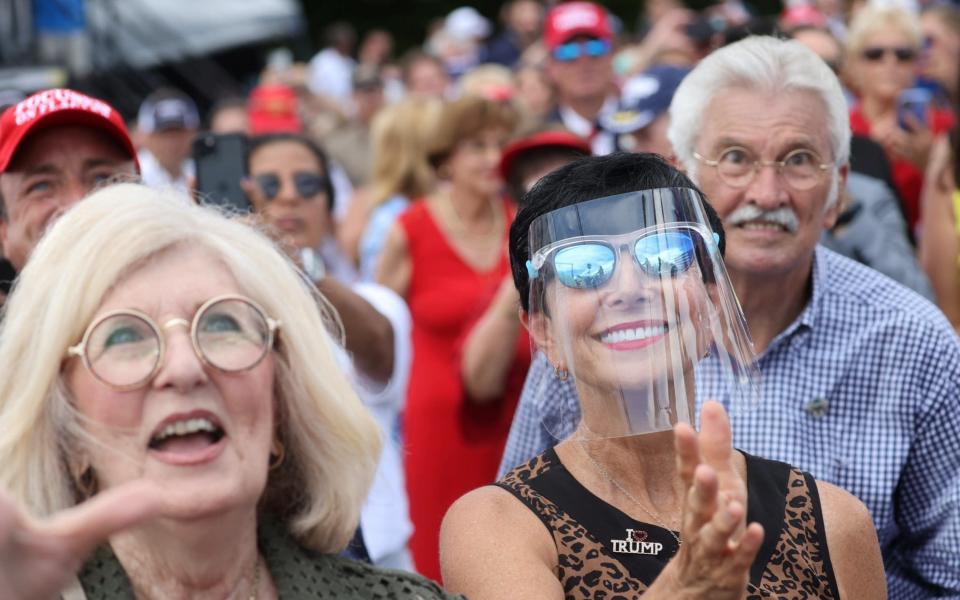 Florida supporters of U.S. President Donald Trump, with few of them wearing masks because of the coronavirus disease (COVID-19) pandemic,  - Reuters