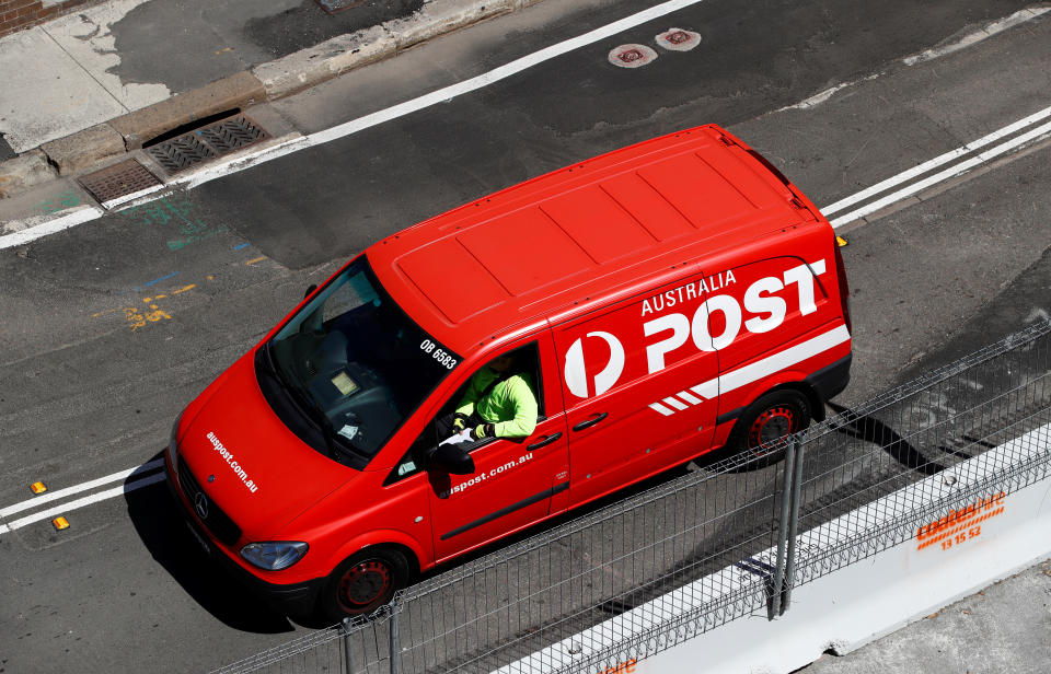 An Australia Post worker drives a van in Sydney, Australia, February 8, 2018. REUTERS/Daniel Munoz
