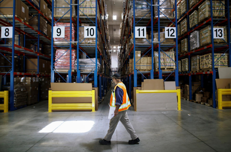 A worker walks in warehouse full of goods to be loaded into trailers equipped with BlackBerry's fleet-tracking service known as Radar, which uses $400 boxes to collect and transmit information on movement, temperature and physical contents of truck trailers, at the Titanium Transportation trucking firm in Bolton, Ontario, Canada on June 7, 2017. Picture taken on June 7, 2017.    REUTERS/Mark Blinch