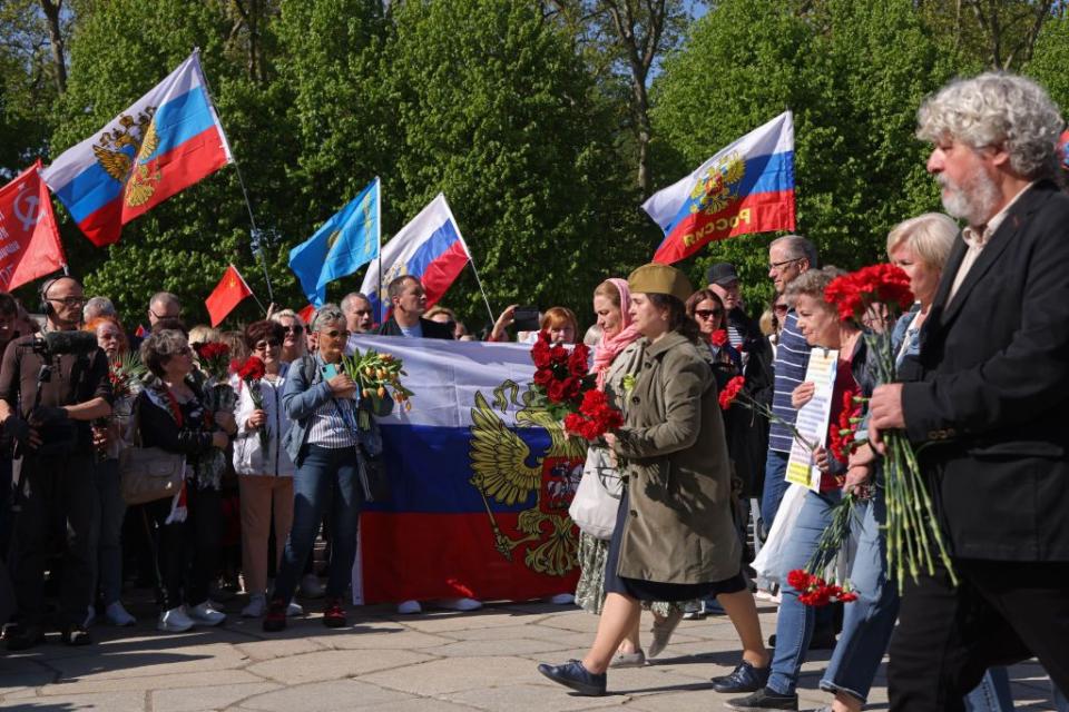 People wave the Russian and Soviet flags at a pro-Russian demonstration hosted by the Russian Embassy in Berlin, Germany, on May 9, 2022, to commemorate the Soviet victory against Nazi Germany in World War II. (Sean Gallup/Getty Images)