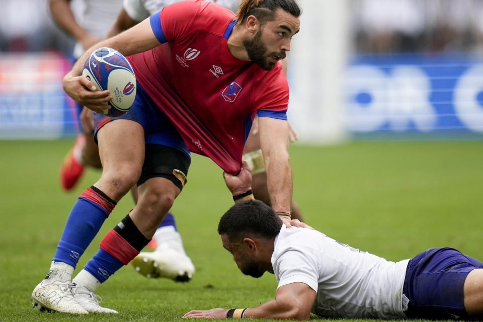 Chile's Inaki Ayarza, left, is tackled by Samoa's Duncan Paia'aua during the Rugby World Cup Pool D match between Samoa and Chile at the Stade de Bordeaux in Bordeaux, France, Saturday, Sept. 16, 2023. (AP Photo/Christophe Ena)