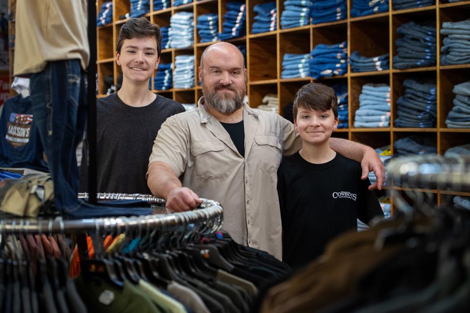 Nathan Jackson, center, owner of Jackson's Western Wear, with his two sons, Cody, 15, left, and Cayden, 11.