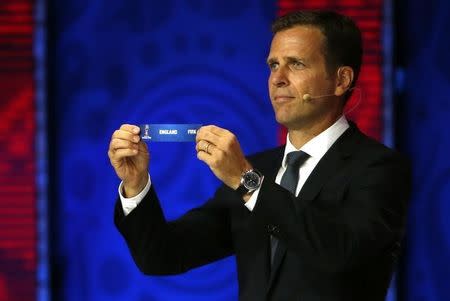 Former German soccer player Oliver Bierhoff holds up the slip showing "England" during the preliminary draw for the 2018 FIFA World Cup at Konstantin Palace in St. Petersburg, Russia July 25, 2015. REUTERS/Grigory Dukor