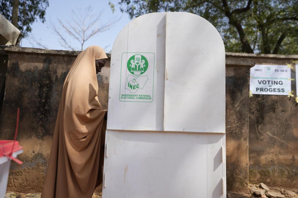 A woman fills her ballot in a booth before casting her vote during the presidential and parliamentary elections in Yola, Nigeria, Saturday, Feb. 25, 2023. Voters in Africa's most populous nation are heading to the polls Saturday to choose a new president, following the second and final term of incumbent Muhammadu Buhari. (AP Photo/Sunday Alamba)