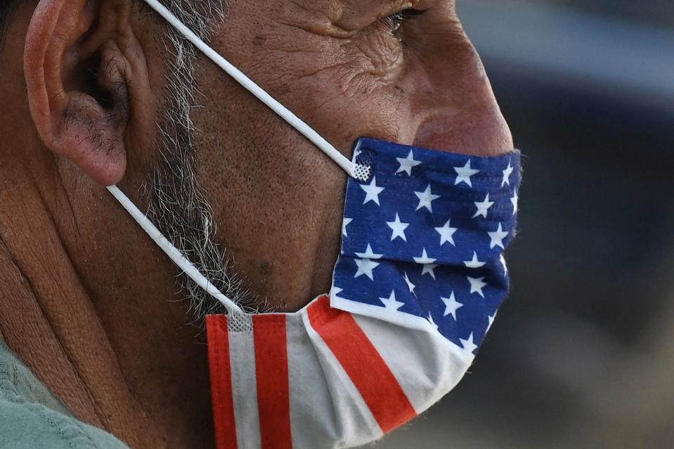 A man wears an American flag face mask on July 19, 2021 on a street in Hollywood, California