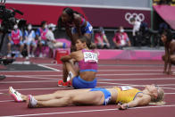 Viktoriya Tkachuk, of Ukraine, lies on the track after the final of the women's 400-meter hurdles at the 2020 Summer Olympics, Wednesday, Aug. 4, 2021, in Tokyo. (AP Photo/Matthias Schrader)