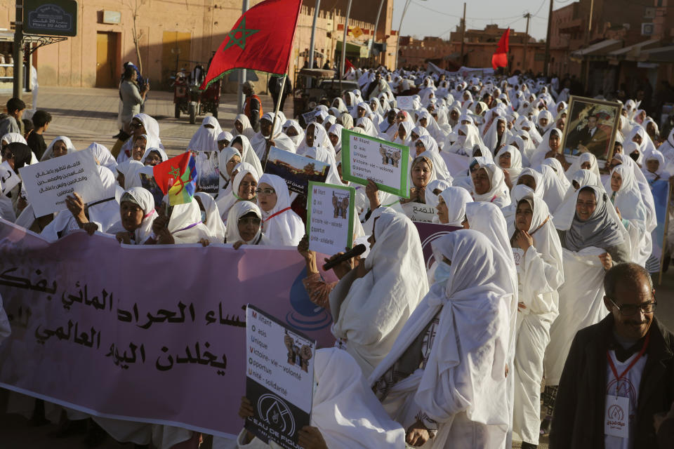 Women take part in a protest against a government plan to change the management of drinking water, in the oasis of Figuig, eastern Morocco, Friday, March 8, 2024. Banner in Arabic reads "Figuig's Women commemorate World Water Day." Regional leaders in Morocco met Thursday, March 21, 2024 with residents of an oasis where many have staged protests over a water management plan. Thousands in the eastern Moroccan town of Figuig have demonstrated against their municipal council’s plan to to transition drinking water management to a regional multi-service agency. (AP Photo)