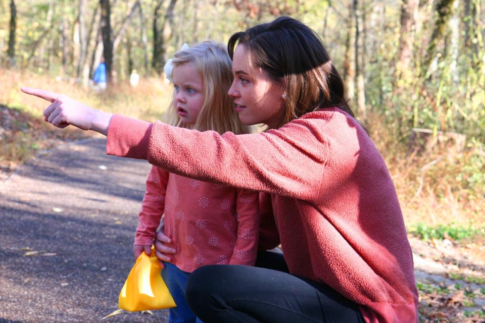 A mother and her daughter plan their trip through the Storybook Trail.