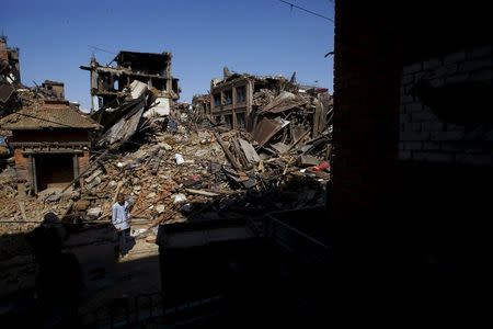 A man walks past collapsed houses following Saturday's earthquake in Bhaktapur, Nepal April 27, 2015. REUTERS/Navesh Chitrakar