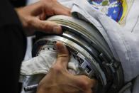 NASA Commercial Crew Astronaut Josh Cassada adjusts the arm during a space suit fitting session at the Johnson Space Center in Houston