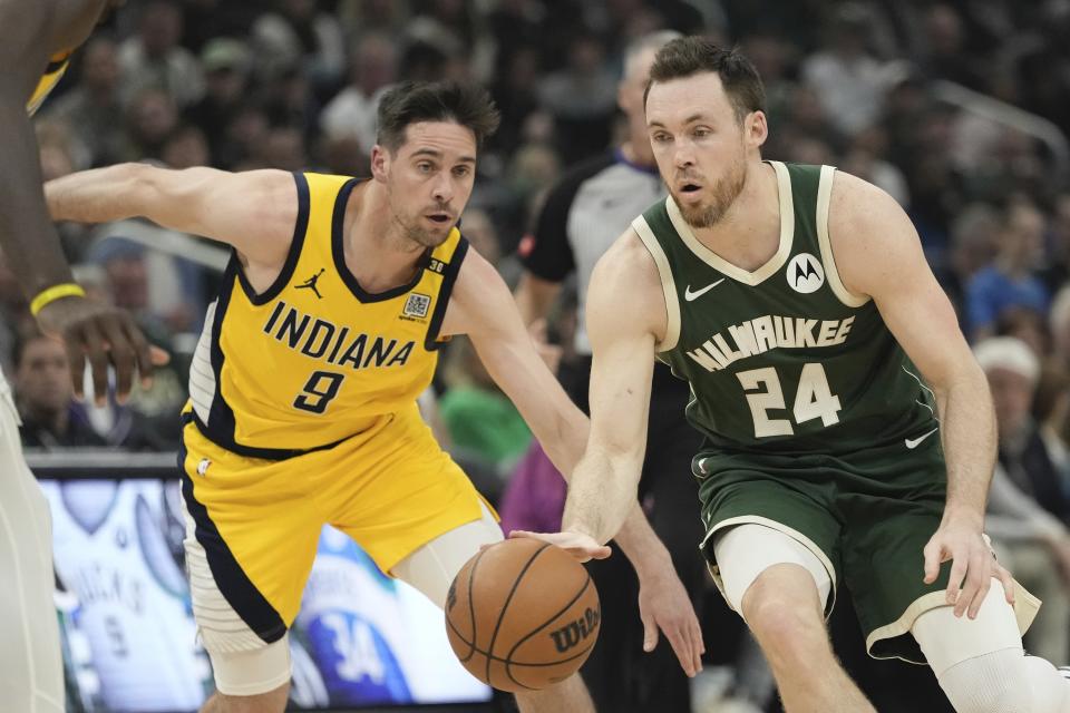 Milwaukee Bucks' Pat Connaughton gets past Indiana Pacers' T.J. McConnell during the first half of Game 5 of the NBA playoff basketball series Tuesday, April 30, 2024, in Milwaukee. (AP Photo/Morry Gash)