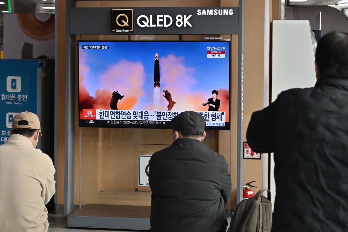 People watch a television news screen showing a picture of North Korea’s recent test-firing of a Hwasong-17 intercontinental ballistic missile (ICBM), at a railway station in Seoul (AFP via Getty Images)