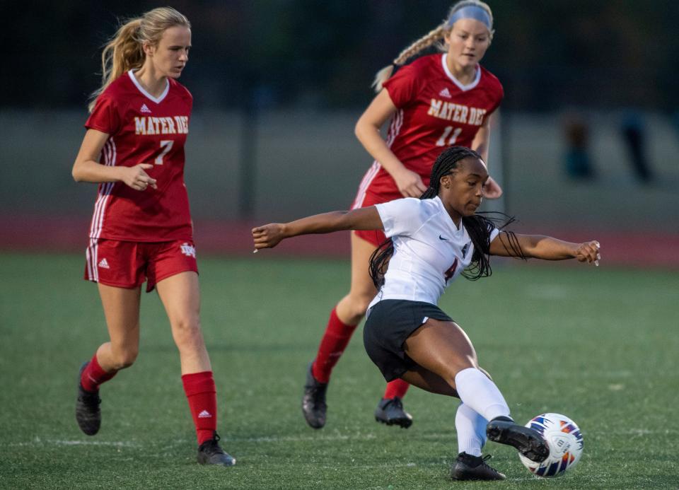 Park Tudor’s Dejanae Butler (4) passes the ball as the Park Tudor Panthers play the Mater Dei Wildcats in the IHSAA Class 1A semi state soccer game in Evansville, Ind., Saturday evening, Oct. 22, 2022. 