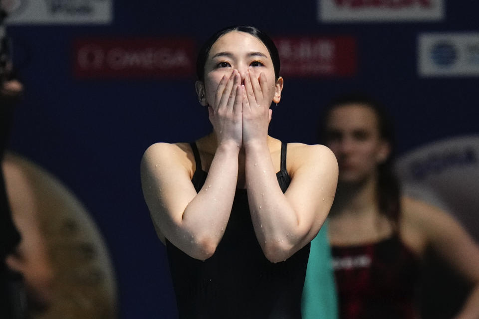 Kim Suji of South Korea reacts as she sees the scoreboard during the women's 3m springboard diving final at the World Aquatics Championships in Doha, Qatar, Friday, Feb. 9, 2024. Kim Suji won the third place. (AP Photo/Hassan Ammar)