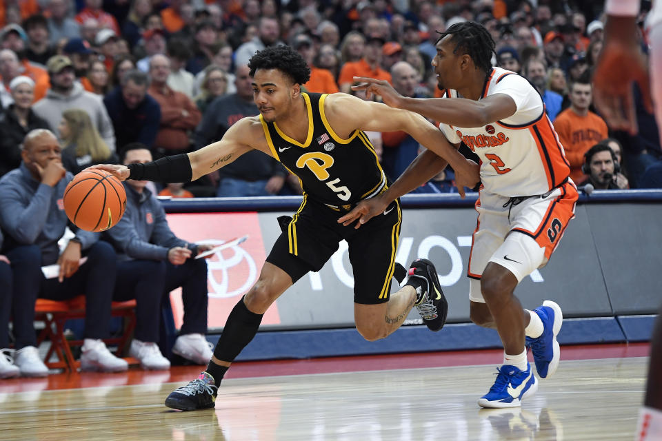 Pittsburgh guard Ishmael Leggett, left, is defended by Syracuse guard J.J. Starling during the first half of an NCAA college basketball game in Syracuse, N.Y., Saturday, Dec. 30, 2023. (AP Photo/Adrian Kraus)