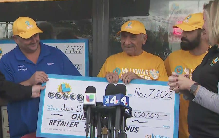 California Lottery officials present Joe Chahayed, the owner of Joe's Service Center, with a $1 million check for selling the jackpot-winning Powerball ticket on Nov. 8, 2022. (KTLA)