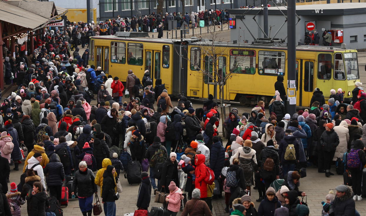 Refugees fleeing the ongoing Russian invasion of Ukraine wait for hours to board a train to Poland, outside the train station in Lviv, Ukraine, March 8, 2022. REUTERS/Kai Pfaffenbach