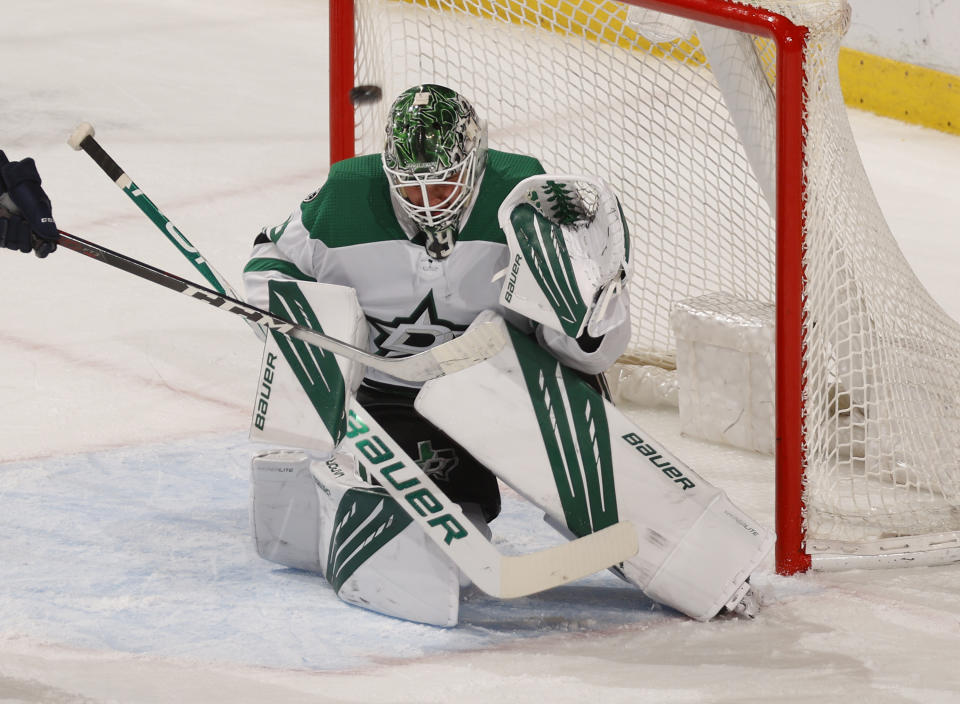 The puck goes over the shoulder of Dallas Stars goaltender Jake Oettinger (29) for the winning goal on a shot by Florida Panthers center Aleksander Barkov during the overtime period of an NHL hockey game, Monday, May 3, 2021, in Sunrise, Fla. (AP Photo/Joel Auerbach)