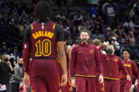 Cleveland Cavaliers' Darius Garland (10) walks off the court as forward Kevin Love, center, greets him in celebration in the second half of an NBA basketball game against the Dallas Mavericks in Dallas, Monday, Nov. 29, 2021. (AP Photo/Tony Gutierrez)