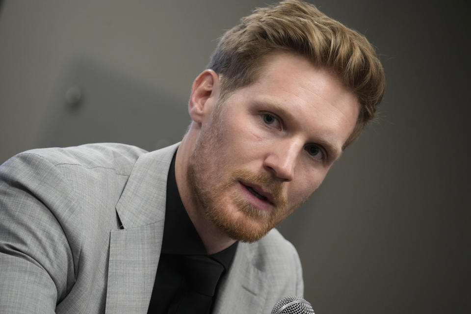 FILE - Injured Colorado Avalanche left wing and captain Gabriel Landeskog talks during a news conference Thursday, April 13, 2023, in Denver. Landeskog attended team meetings Tuesday, April 16, 2024, and watched practice from the bench. His status, though, remains the same — uncertain. The 31-year-old Landeskog had cartilage replacement surgery on his right knee last May and is missing a second straight season. (AP Photo/David Zalubowski, File)