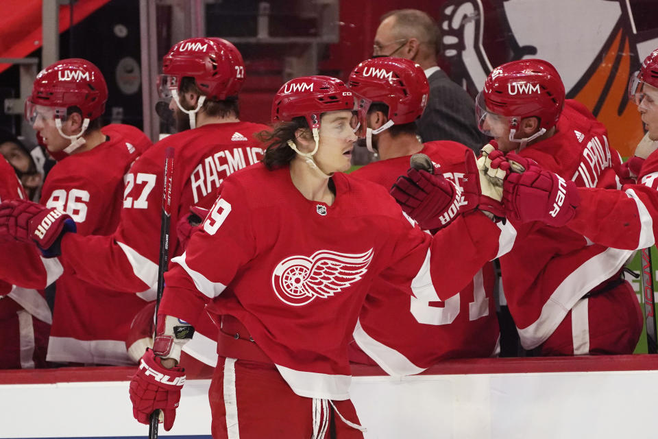 Detroit Red Wings left wing Tyler Bertuzzi greets teammates after scoring during the first period of an NHL hockey game against the Florida Panthers, Saturday, Jan. 30, 2021, in Detroit. (AP Photo/Carlos Osorio)