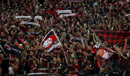 FILE PHOTO: Chinese fans of AC Milan wave with their mobile phones during the end of the International Champions Cup friendly match between AC Milan and Inter Milan in Shenzhen, China July 25, 2015. REUTERS/Bobby Yip/File Photo