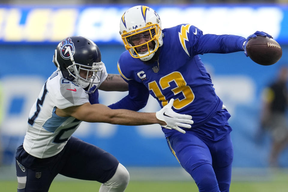 Los Angeles Chargers wide receiver Keenan Allen (13) runs against Tennessee Titans cornerback John Reid during the second half of an NFL football game in Inglewood, Calif., Sunday, Dec. 18, 2022. (AP Photo/Marcio Jose Sanchez)
