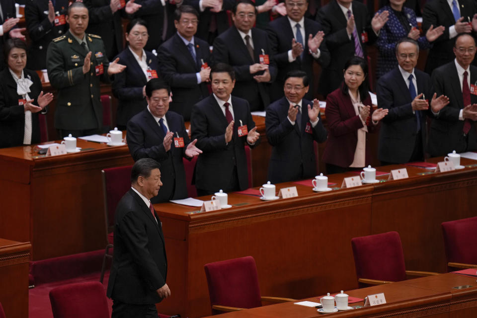 Delegates applaud as Chinese President Xi Jinping, bottom, arrives to the closing session of the National People's Congress (NPC) at the Great Hall of the People in Beijing, Monday, March 11, 2024. (AP Photo/Andy Wong)