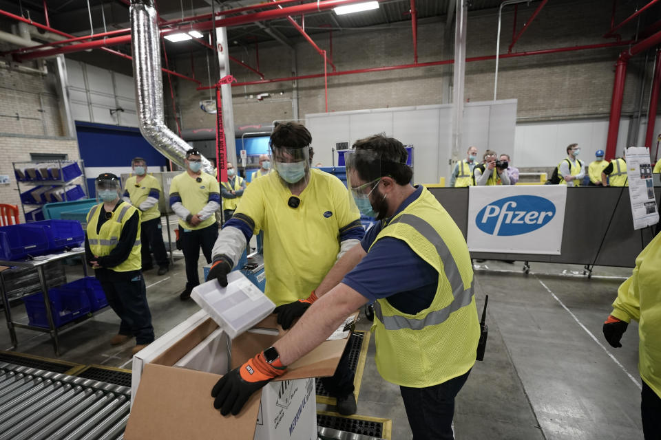 FILE - In this Dec. 13, 2020 file photo, Boxes containing the Pfizer-BioNTech COVID-19 vaccine are prepared to be shipped at the Pfizer Global Supply Kalamazoo manufacturing plant in Portage, Mich. Pfizer has committed to supply up to 40 million doses of its COVID-19 vaccine this year to a World Health Organization-backed effort to get affordable vaccines to 92 poor and middle-income countries. The deal announced Friday, Jan. 22, 2021 will supply the shots to the program known as COVAX. (AP Photo/Morry Gash, Pool, File)