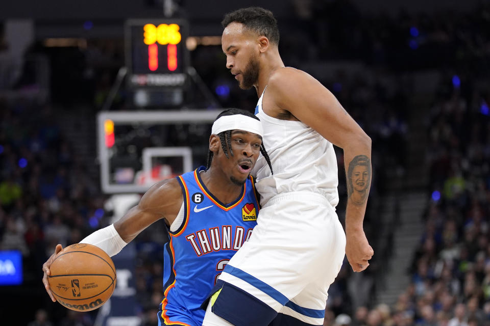 Oklahoma City Thunder guard Shai Gilgeous-Alexander (2) is defended by Minnesota Timberwolves forward Kyle Anderson (5) during the second half of an NBA basketball game, Wednesday, Oct. 19, 2022, in Minneapolis. (AP Photo/Abbie Parr)