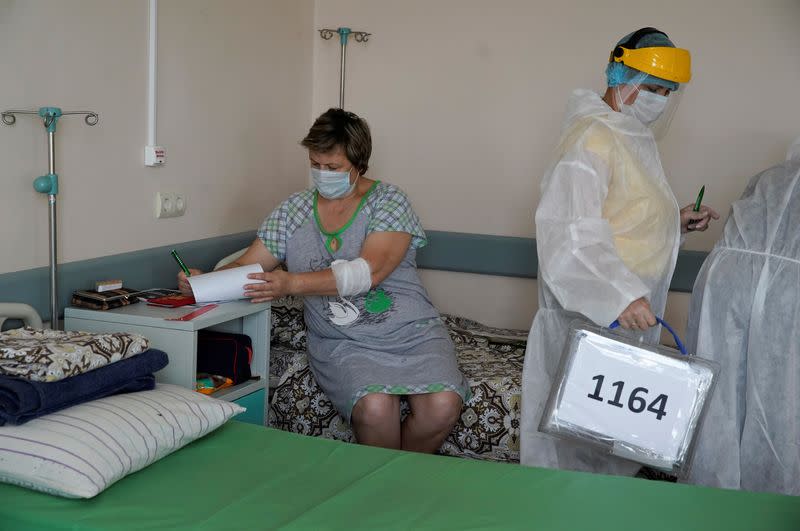 Members of an electoral commission visit a regional hospital during a nationwide vote on constitutional reforms in Tver