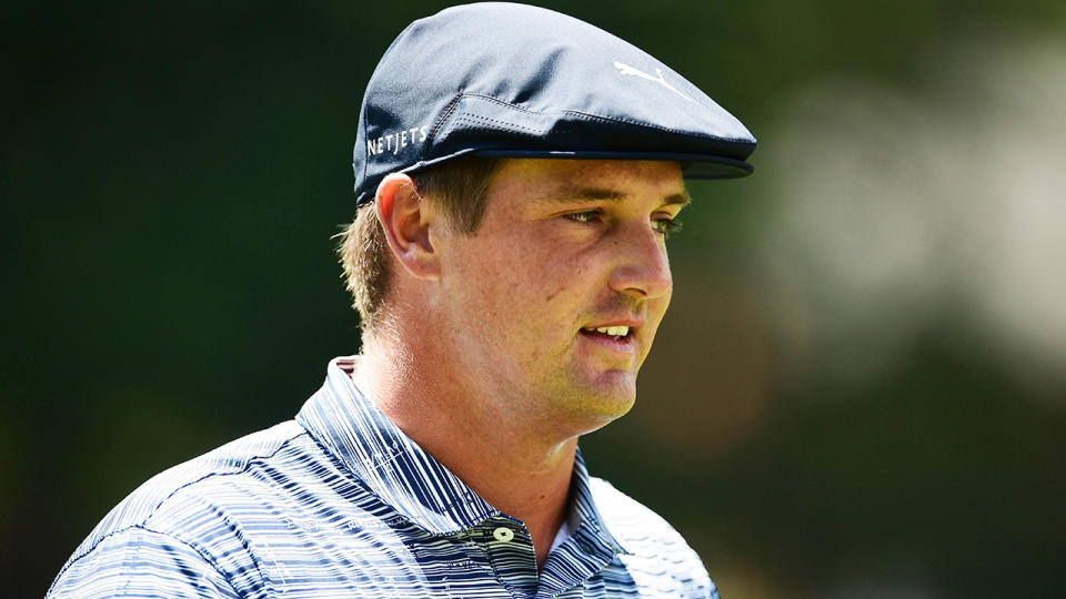 Bryson DeChambeau is pictured surveying the green during the Rocket Mortgage Classic.