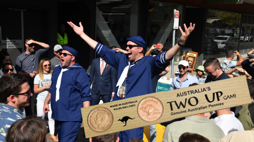 A composite image of Australian playing two-up on ANZAC day and a classic two-up playing paddle.