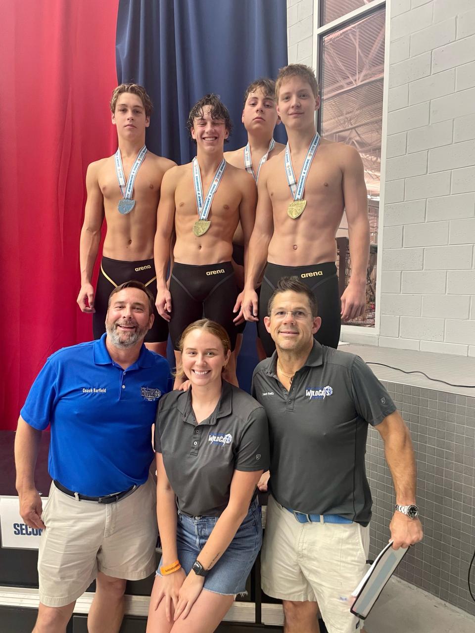 (From Top Left to Right) Booker T. Washington's Ian Malone, Coulson Voeltz, Logan Robinson and Max Little are joined by coaches at the podium after winning the 200-yard medley relay during the Class 3A State Championship on Saturday, Nov. 11, 2023 from in Ocala.